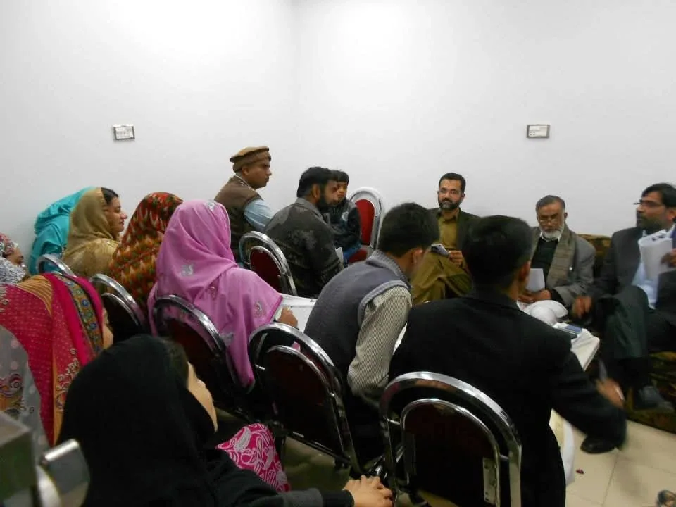 Doctors seated around a room with Dr. Mir Zahed at a study session on the Sensation Method.