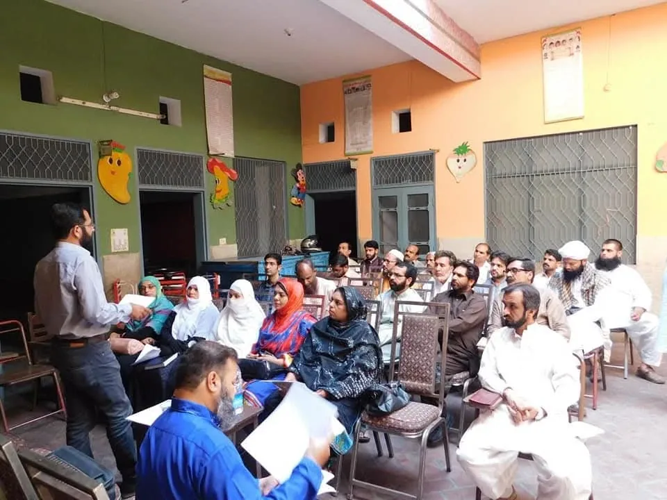 Dr. Mir Zahed standing before a seated room of doctors, teaching a repertory workshop.